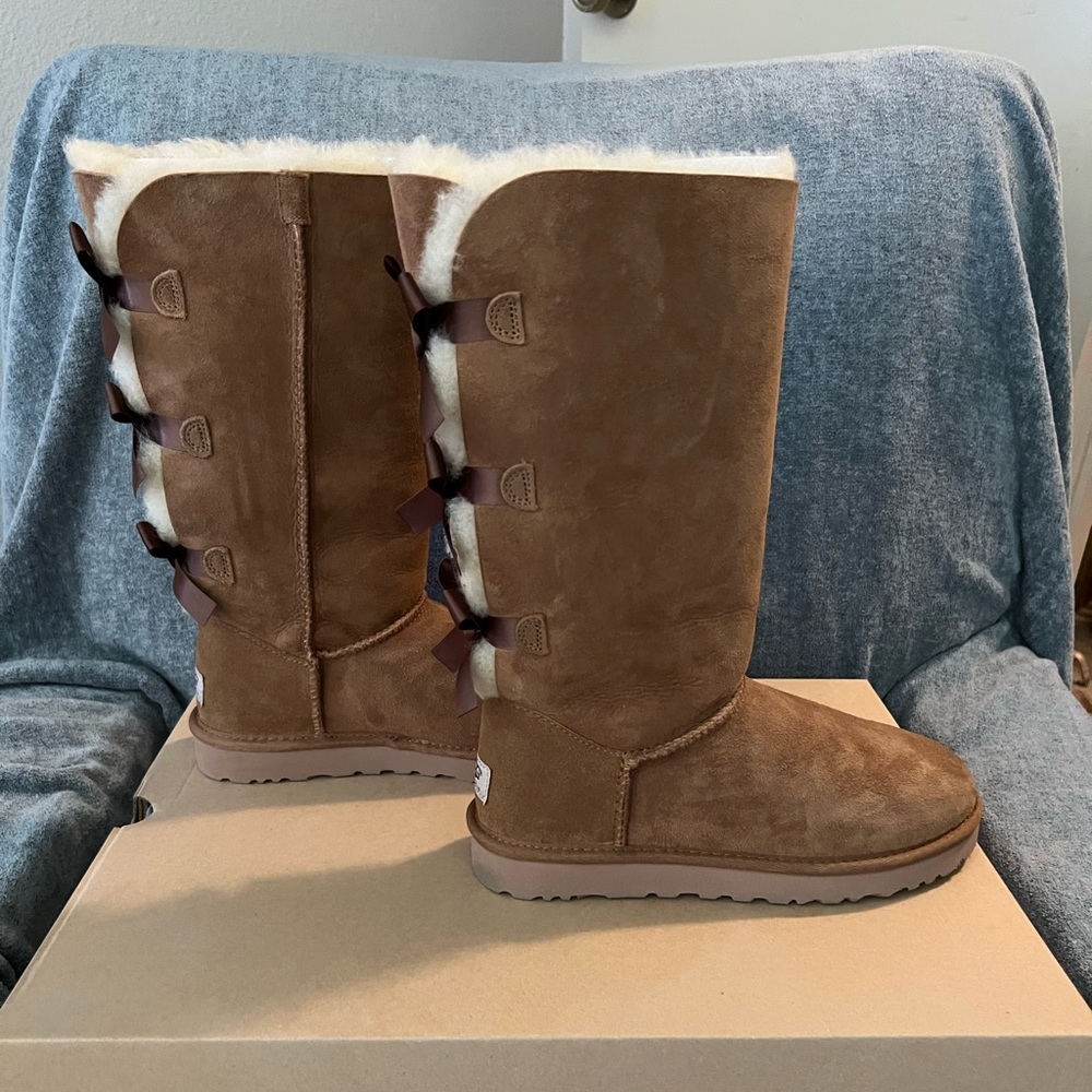 Brand new, brown, UGG tall Bailey bow boots, in size 7.
